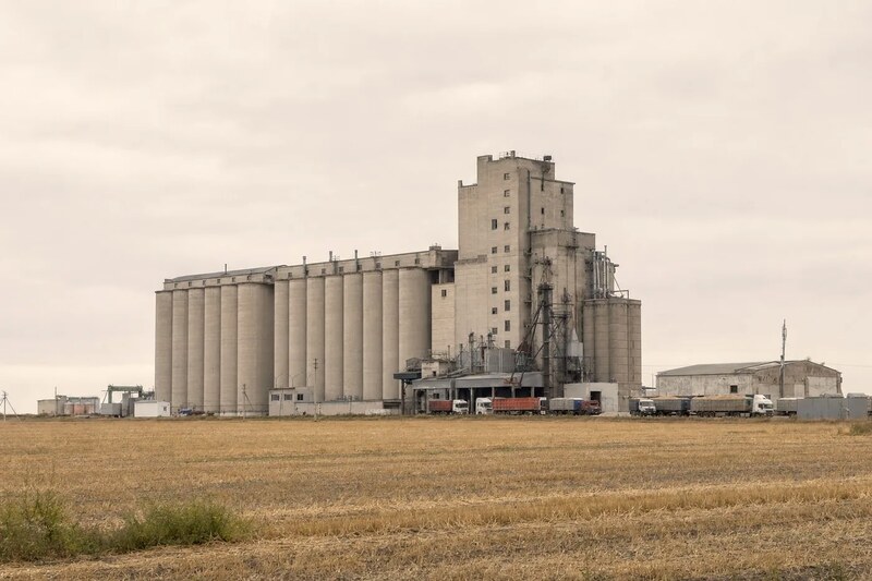 Grain elevator complex with concrete silos and loading gallery in the northern Kazakh grain belt